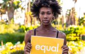 African American woman holding an equal sign.