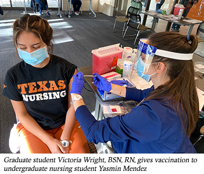 Graduate student Victoria Wright, BSN,RN, gives vaccination to undergraduate nursing student Yasmin Mendez