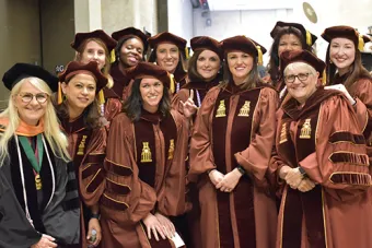 Nursing students dressed on caps and gowns
