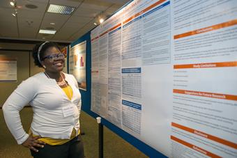 Student infront of her research poster