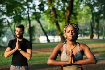 People doing yoga in a park