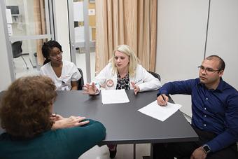 Students from Nursing, Pharmacy, Medicine and Social Work collaborate on a patient case.