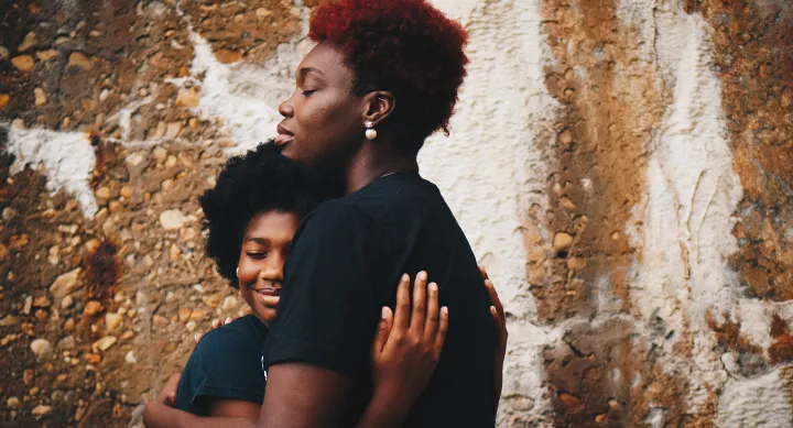 African American mother and kid holding each other