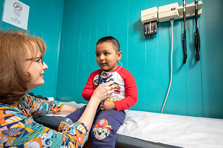A kid being examined by a nurse at the Children’s Wellness Center